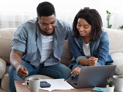 image of Man and woman happily working on their laptop