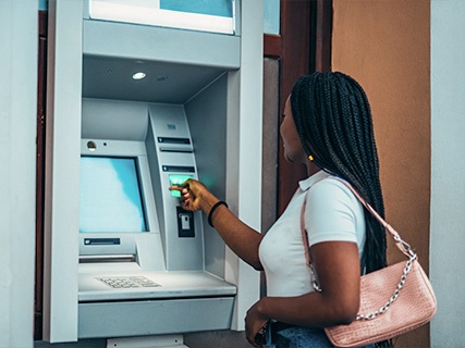 Woman withdrawing cash from an ATM