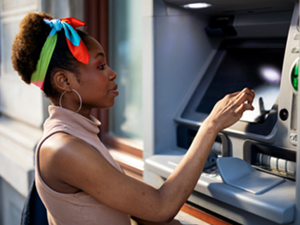 Image of Woman withdrawing cash from an ATM