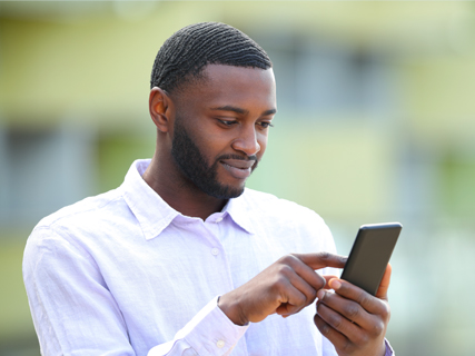 Image of man typing on his mobile phone