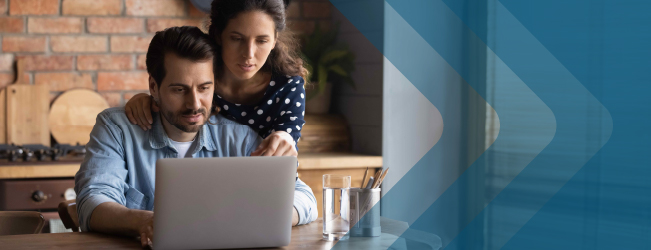 Man and woman reading information on laptop in their preferred language