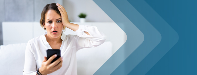 woman reading information on her cell phone looking concerned