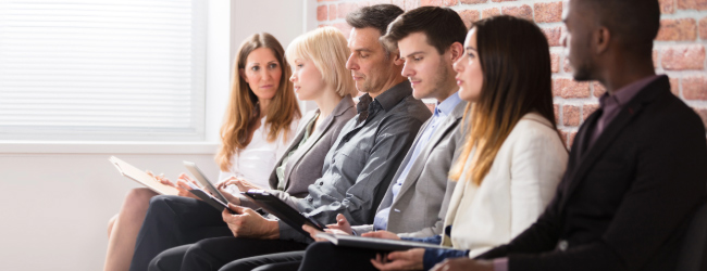 Several people sitting in an office environment.
